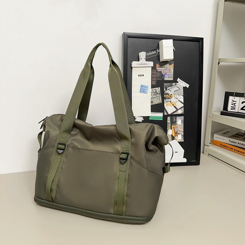 Sporty shoulder bag with water-repellent material and sturdy carrying handles Stornfield