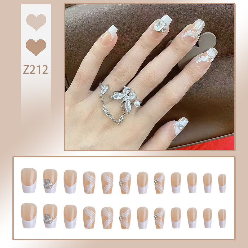 Elegant artificial nail set with delicate decorations and glitter elements Stornfield