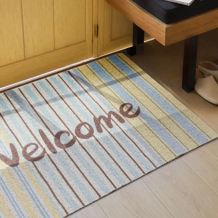 Durable entrance doormat with striped texture and "Welcome" lettering Stornfield