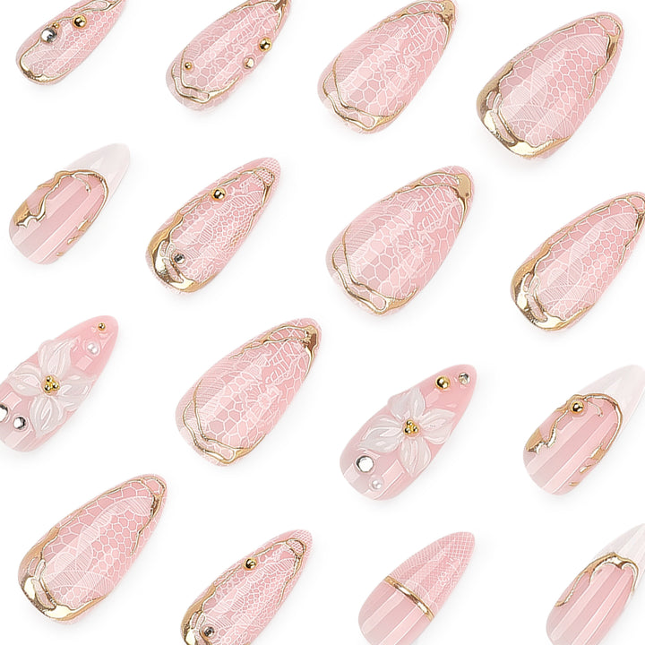 Artful nail extensions with delicate flower and gold embellishments Stornfield