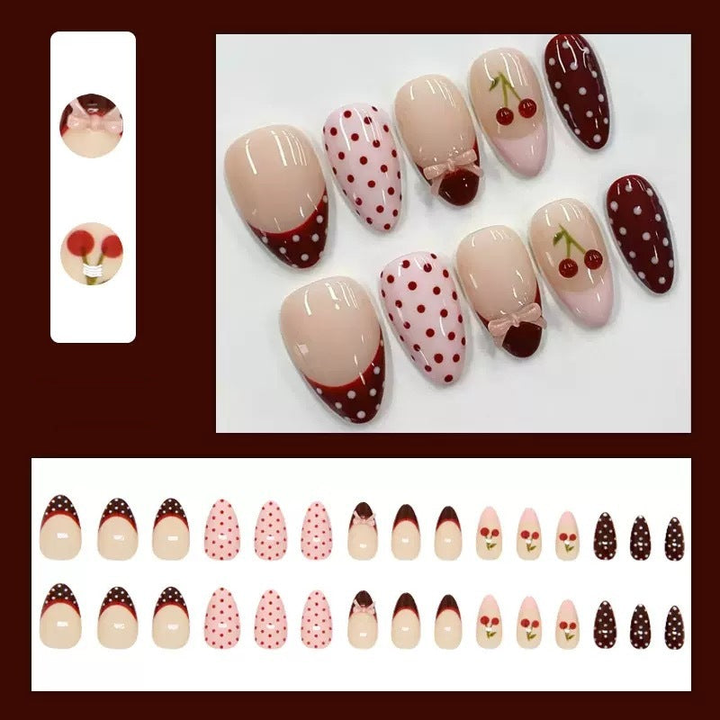 Artfully designed nail tips with cherry and dot motifs Stornfield