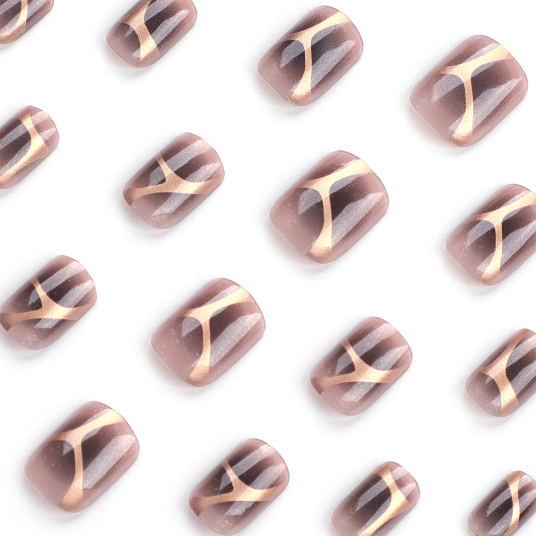 Artificial nail art with elegant metallic design and glitter accents Stornfield