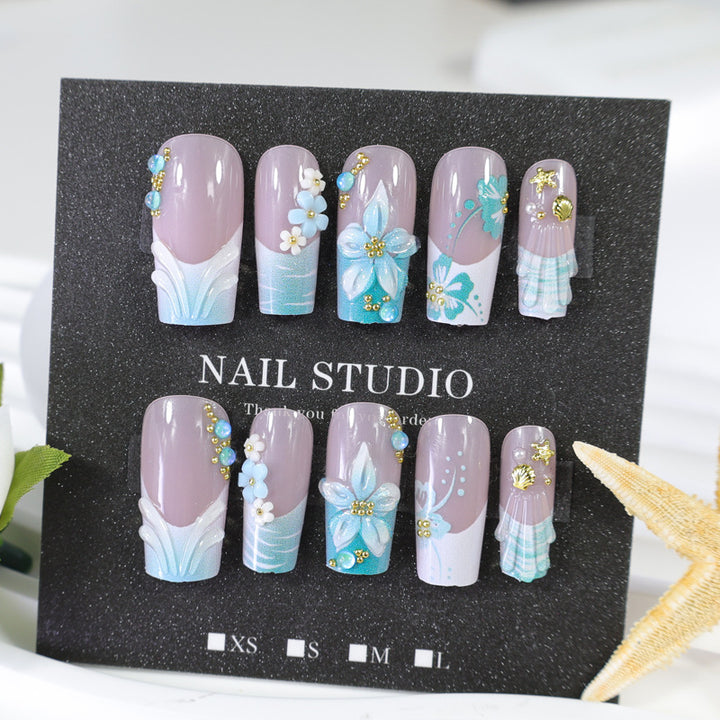 Acrylic nail set with elegant floral decorations and glitter accents Stornfield