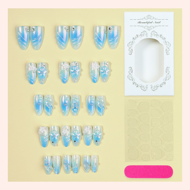 Artificial nail creation with floral designs and glitter accents Stornfield
