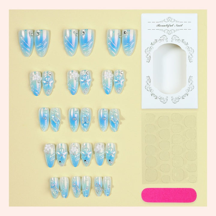 Artificial nail creation with floral designs and glitter accents Stornfield