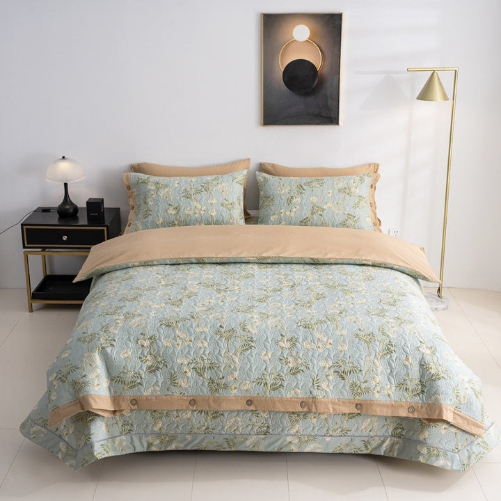 Quilted bedspread and bedding set with floral print, reversible function and decorative button placket