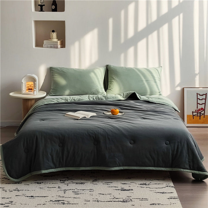 Light reversible quilted blanket made of microfiber with soft decorative stitching