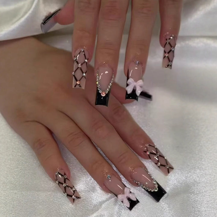 Artificial nail set with glamorous rhinestone and bow accents Stornfield