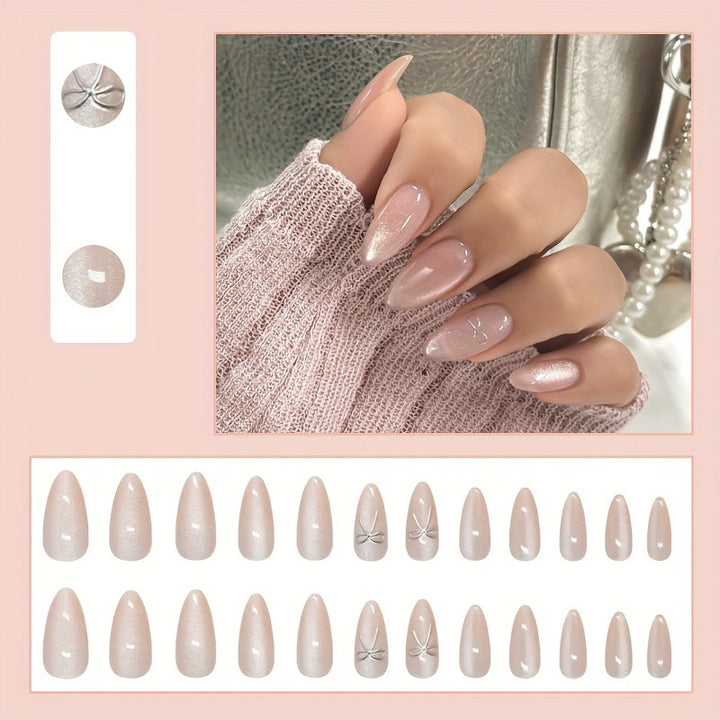Artificial nail set with delicate glitter and elegant bow decorations Stornfield