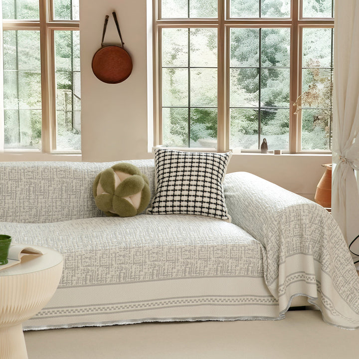 Washable sofa cover with geometric jacquard pattern and non-slip underside