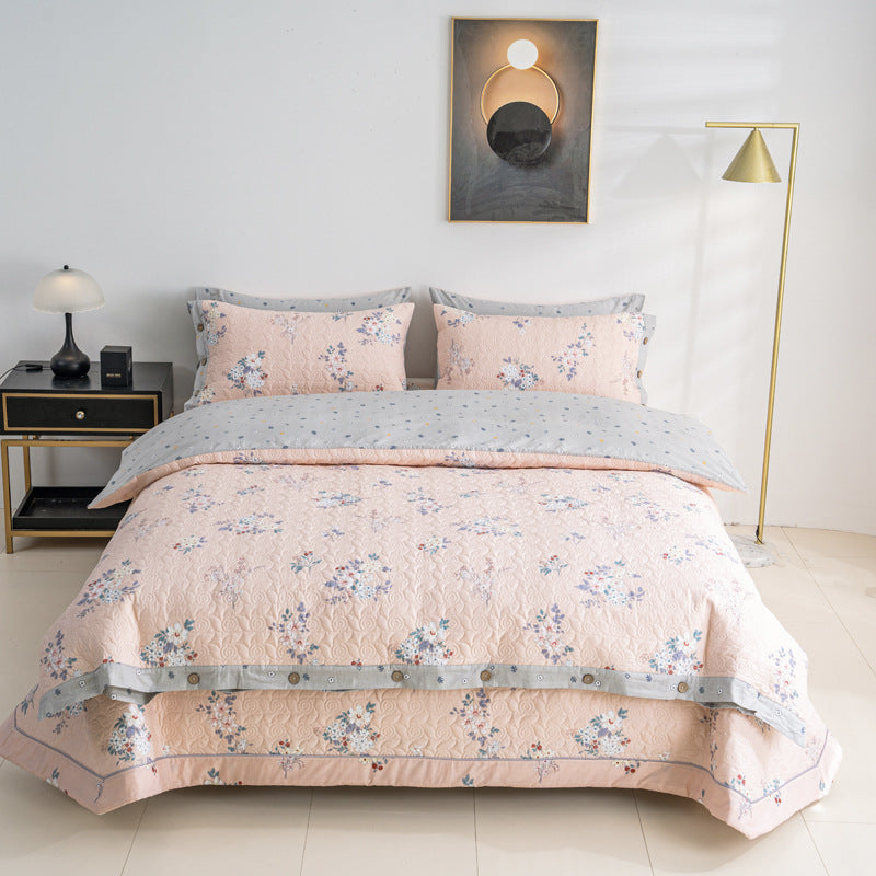 Quilted bedspread and bedding set with floral print, reversible function and decorative button placket
