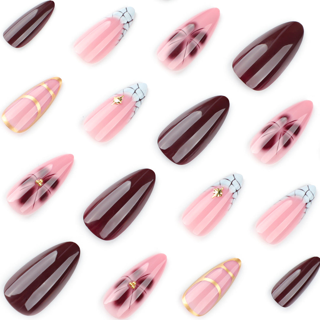 Artful Stiletto nails with gold accents and decorative floral designs Stornfield