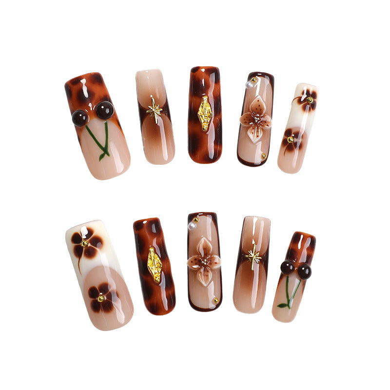 Elegant nail art set with floral and golden accents Stornfield