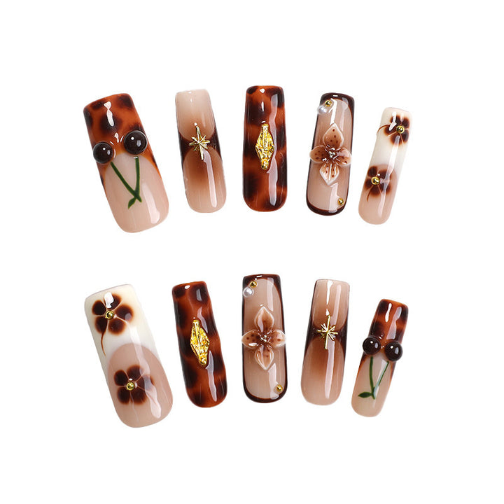 Elegant nail art set with floral and golden accents Stornfield