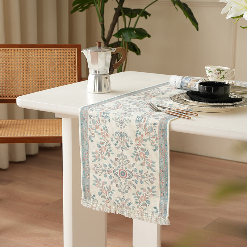 Jacquard table runner with floral border pattern and fringes