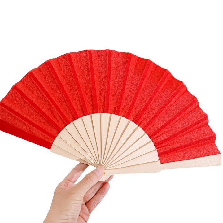 Ladies folding hand fan made of airy material with intricate folds Stornfield