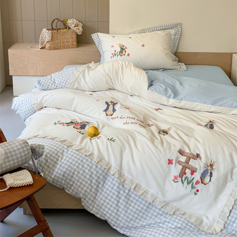 Romantic bedding set with embroidered rabbit motifs and delicate ruffles