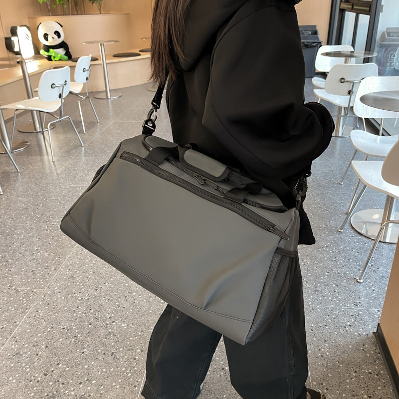 Sporty travel bag with reinforced carrying handles and multiple compartments Stornfield