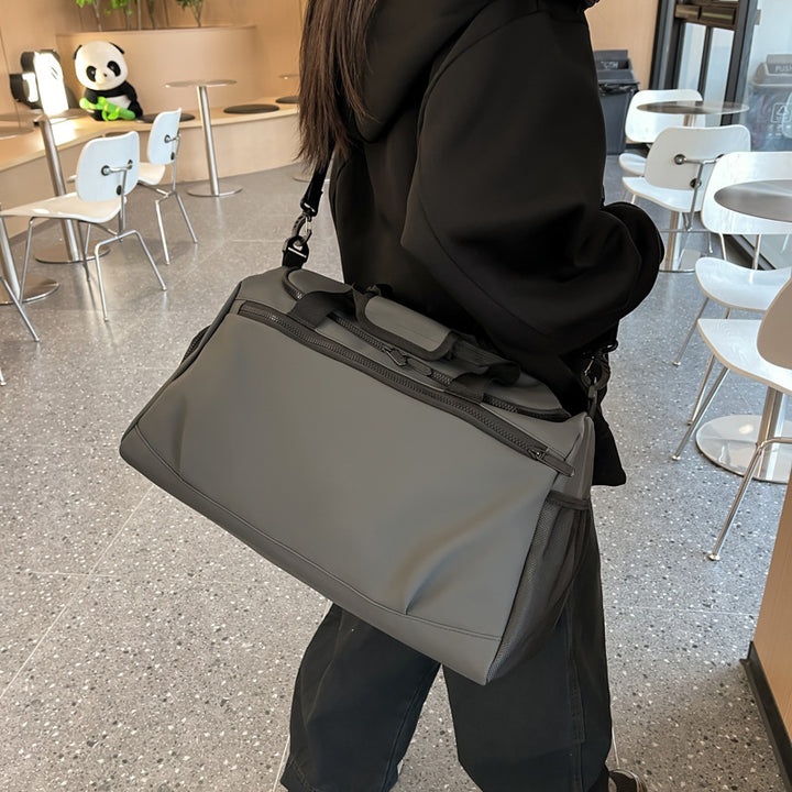 Sporty travel bag with reinforced carrying handles and multiple compartments Stornfield
