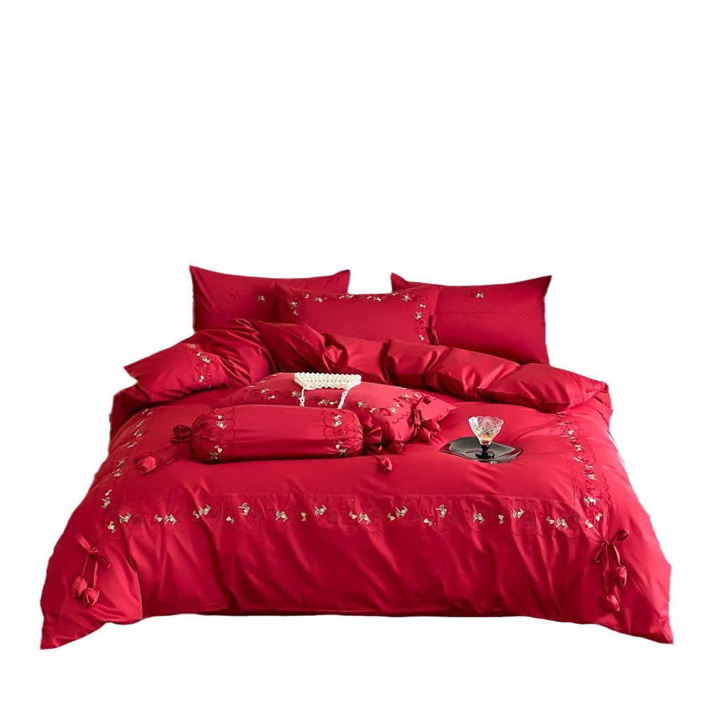 Opulent Satin bedding set with floral embroidery, decorative rolls and ruffled hem