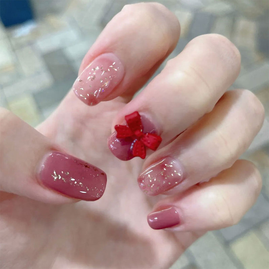 Artificial nail art with glitter embellishments and cute bow motif Stornfield