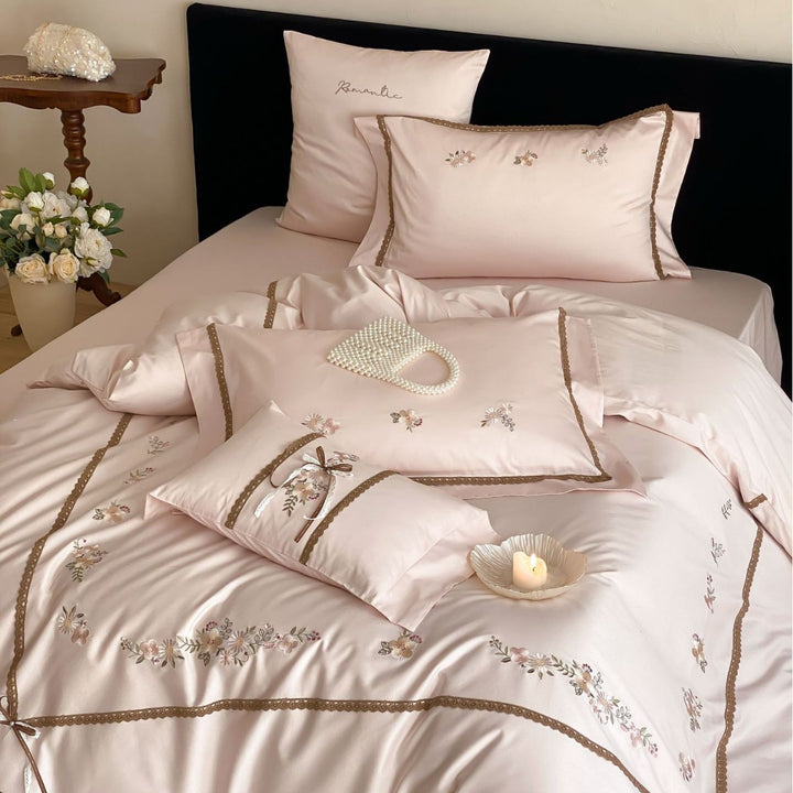 Embroidered bed linen set made of cotton satin with lace trim and floral appliqués