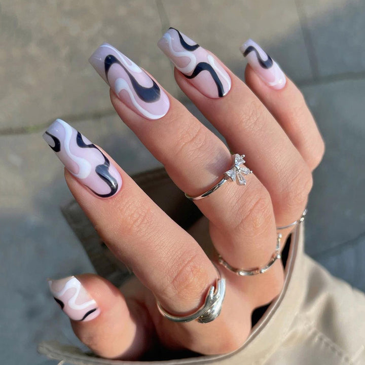 Artful nail extensions with elegant curved patterns Stornfield