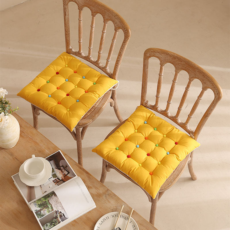 Padded quilted seat cushion with colorful button applications and non-slip underside Stornfield
