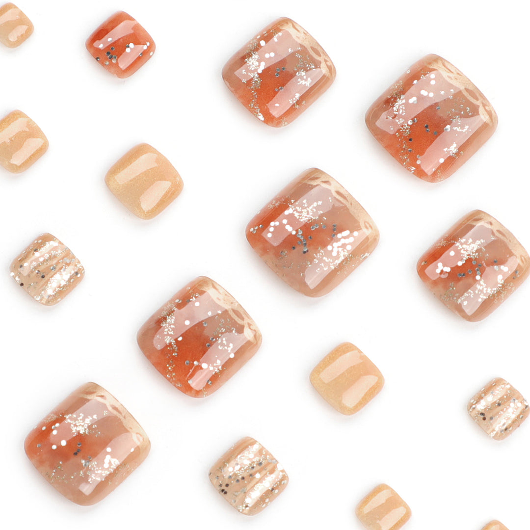 Artistic toenail design with glitter and golden accents Stornfield