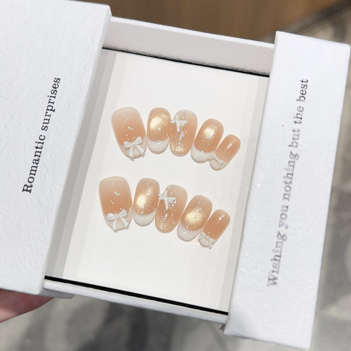 Artificial nails with romantic bow and glitter effects Stornfield