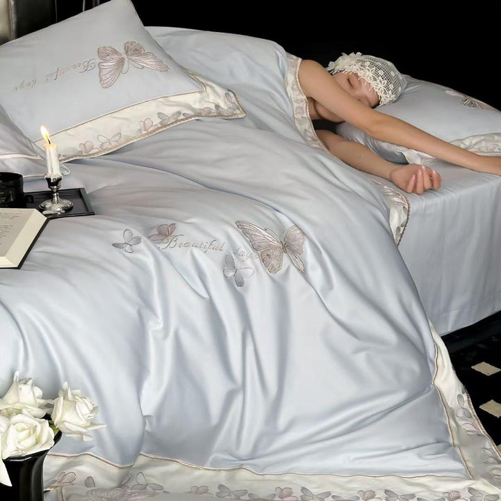 Satin bedding set with embroidered butterfly motif and silk-matte finish