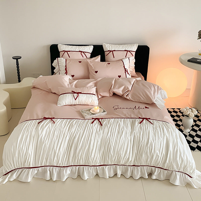 Romantic bedding set with ruffles, heart embroidery and luxurious satin look