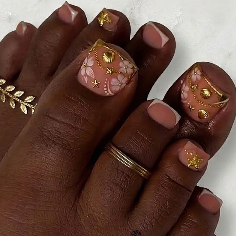 Artificial nail set with elegant, floral accents and golden decorations Stornfield