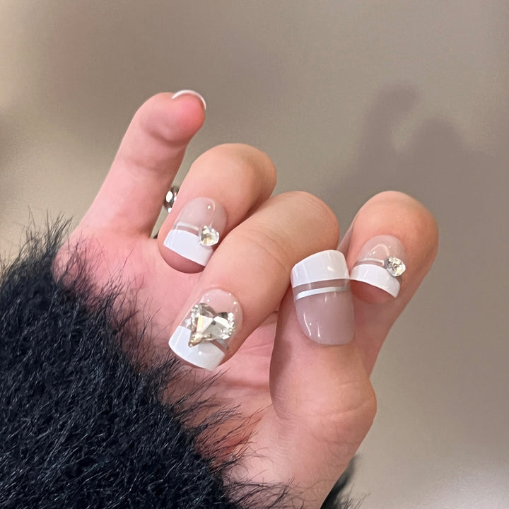 Elegant Nail Art with Glitter Accents and Jewelry Details Stornfield