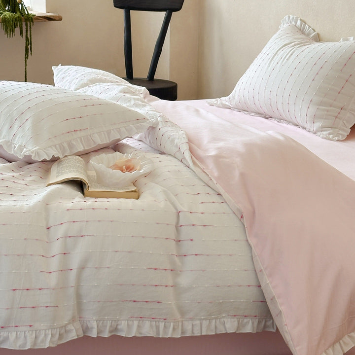 Bedding set made of lightweight cotton muslin with fine line embroidery and ruffled border