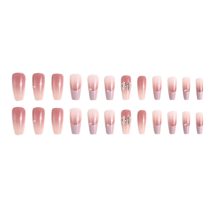 Artificial nail set with elegant ombre design and delicate bow embellishments Stornfield