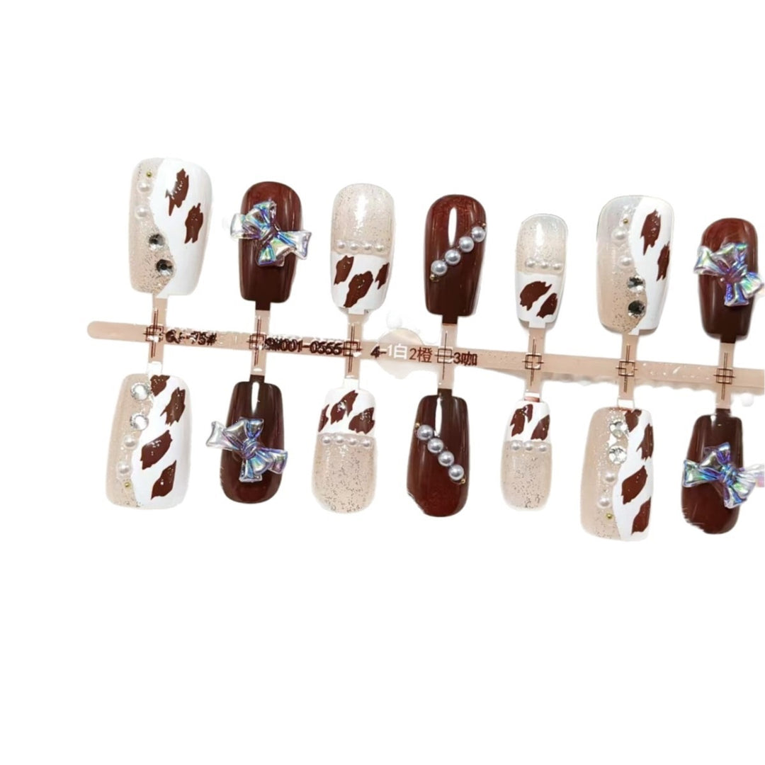 Artificial nails with sparkling rhinestone and bow accents Stornfield