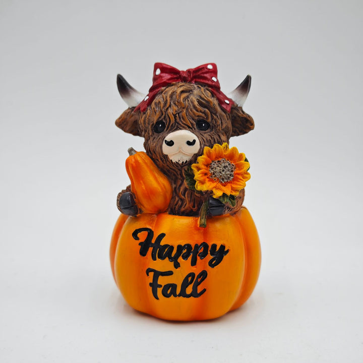 Funny decorative figure of a Highland cow in pumpkin costume Stornfield
