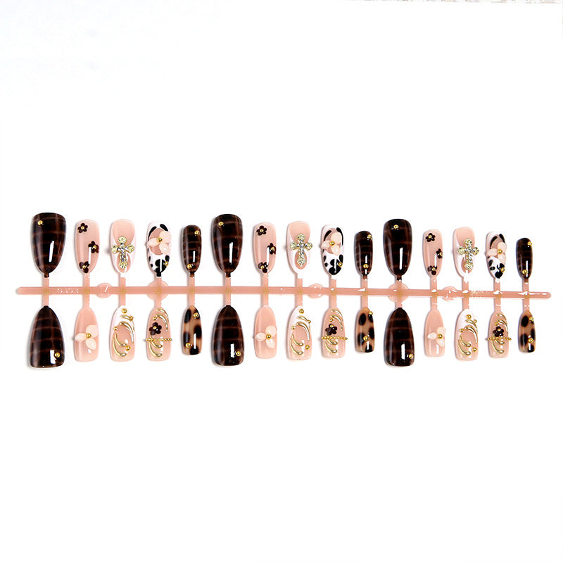 Artificial nails set with elegant gold accents and floral embellishments Stornfield
