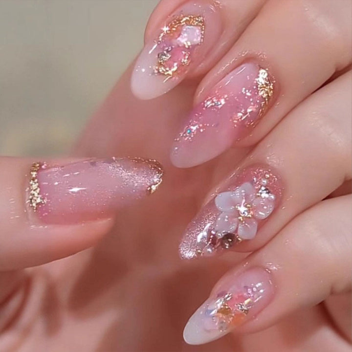 Artificial nails with delicate floral decorations and glitter effects Stornfield