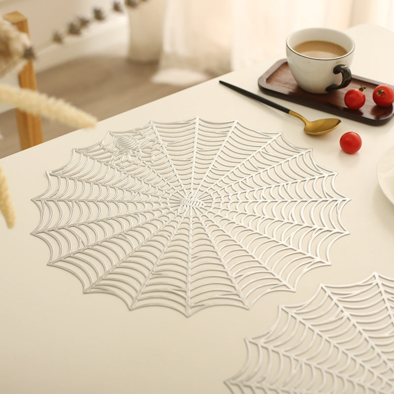 Round filigree spider web placemat made of heat- and water-repellent PVC for table decoration