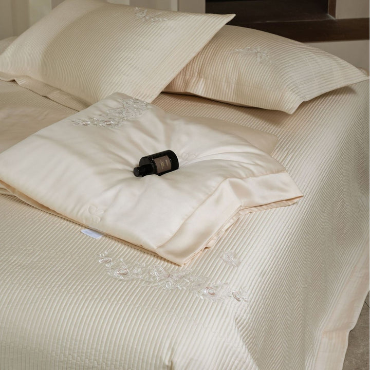 Luxurious cotton satin bedding set with quilted bedspread and floral embroidery