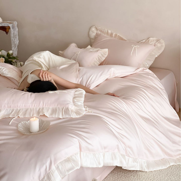 Satin bedding set with ruffle edges, delicate bow appliqué and pillowcases