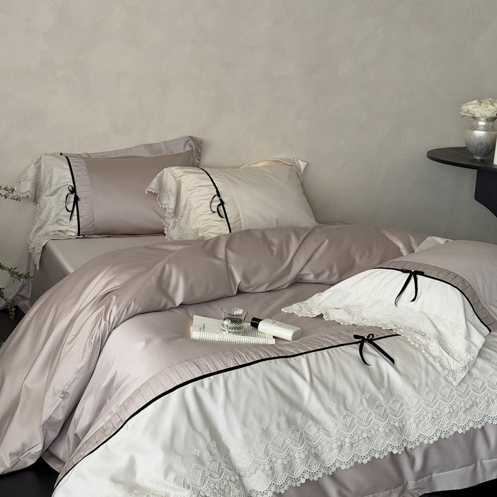 Romantic satin bedding set with lace trim, pleated detail and satin bows