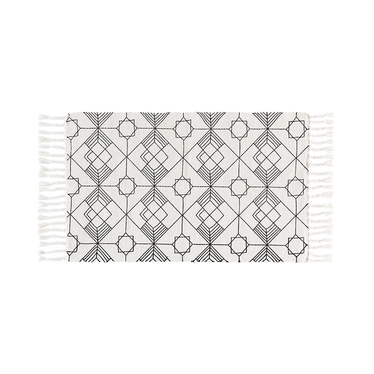 Flat-woven cotton table runner in Art Deco geometry jacquard with hand-fringed edge