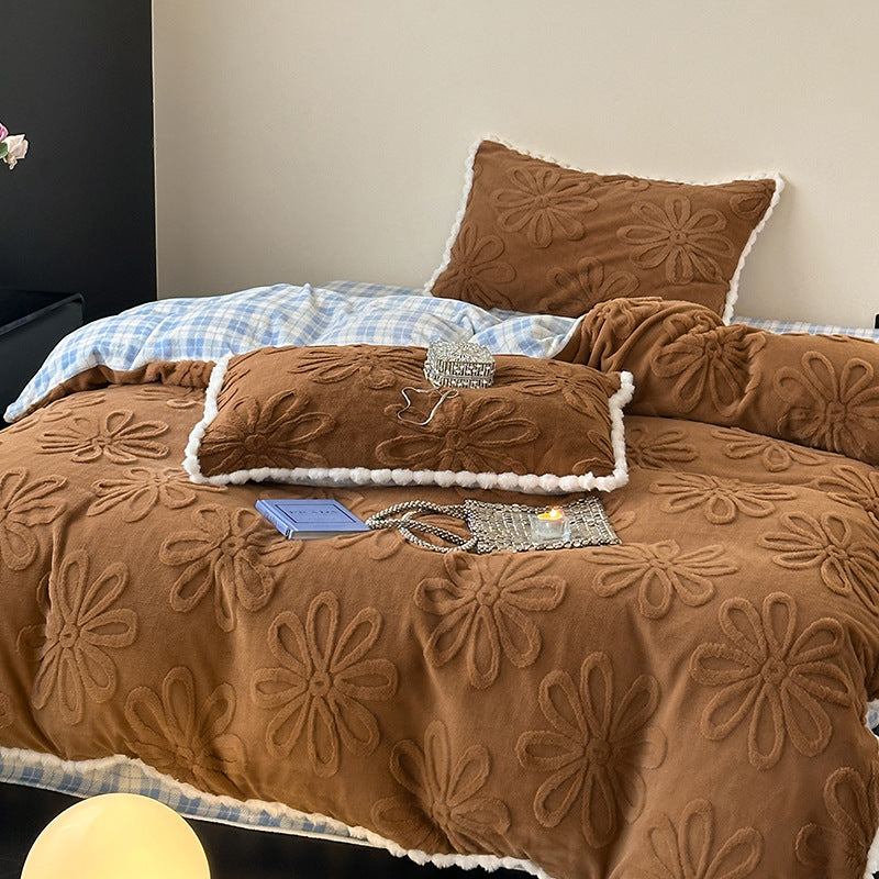 Plush bedding set with embossed floral relief and teddy trim
