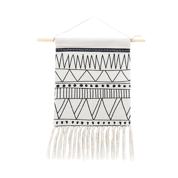 Woven wall hanging made of cotton blend with wooden rod, fringes and geometric ethnic pattern