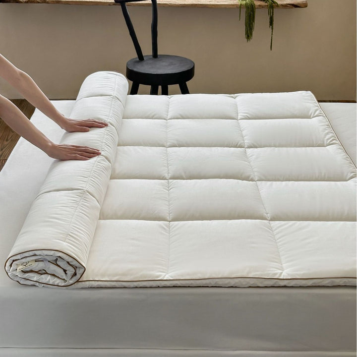 Padded comfort topper with quilted compartments and elastic corner bands