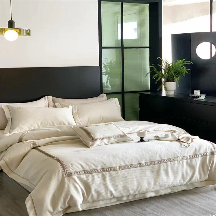 Exclusive satin bedding set with fine piping and monogram embroidery