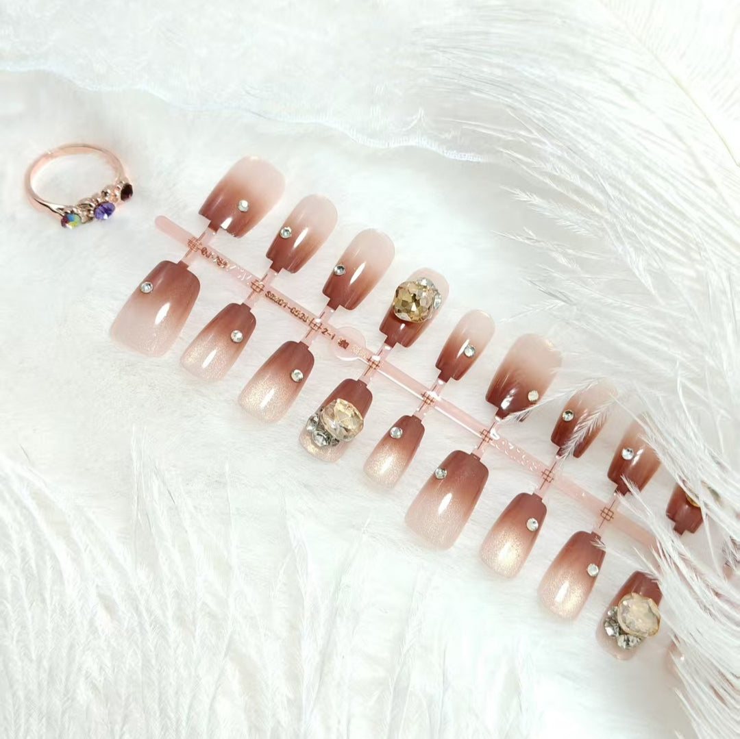 Artificials nails in elegant ombre style with rhinestone embellished applications Stornfield